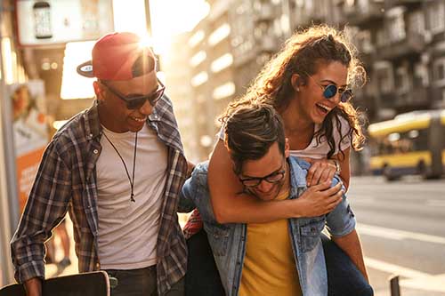 friends laughing on sidewalk