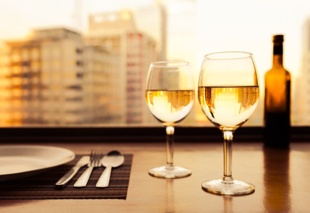 Glasses of white wine with city view.