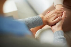 individuals holding hands in acceptance and commitment therapy