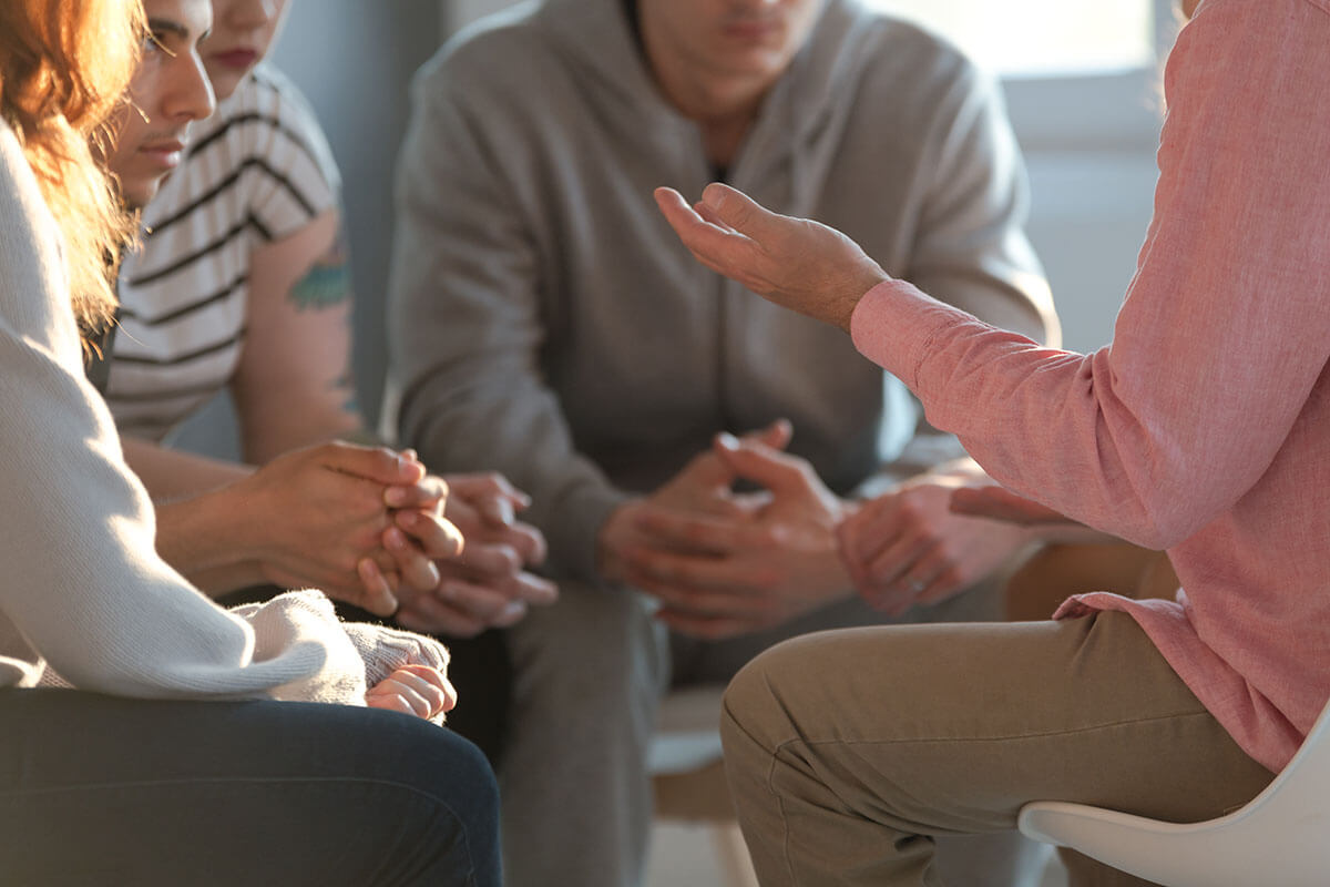 people talking in a group counseling session