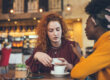 Friends at cafe discussing broken trust in a relationship