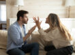 Couple in a toxic relationship sitting on couch having a heated argument