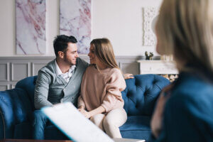 couple smiling at one another while rebuilding their bond in couples therapy