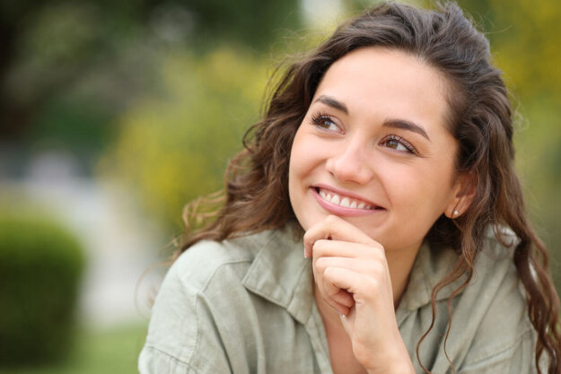 Am I Manic or Just Happy – Uncovering Bipolar Disorder person smiling while looking up to the sky and wondering am I manic or just happy