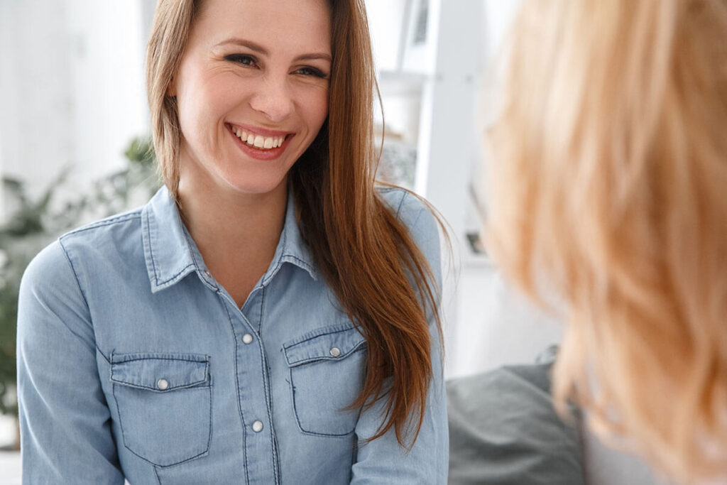 person smiling in therapy session while receiving motivation for change in recovery