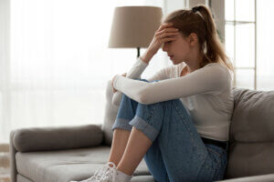 A woman wondering, "What triggers an anxiety attack?"